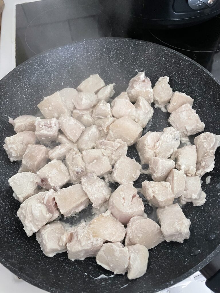 Diced chicken in a frying pan