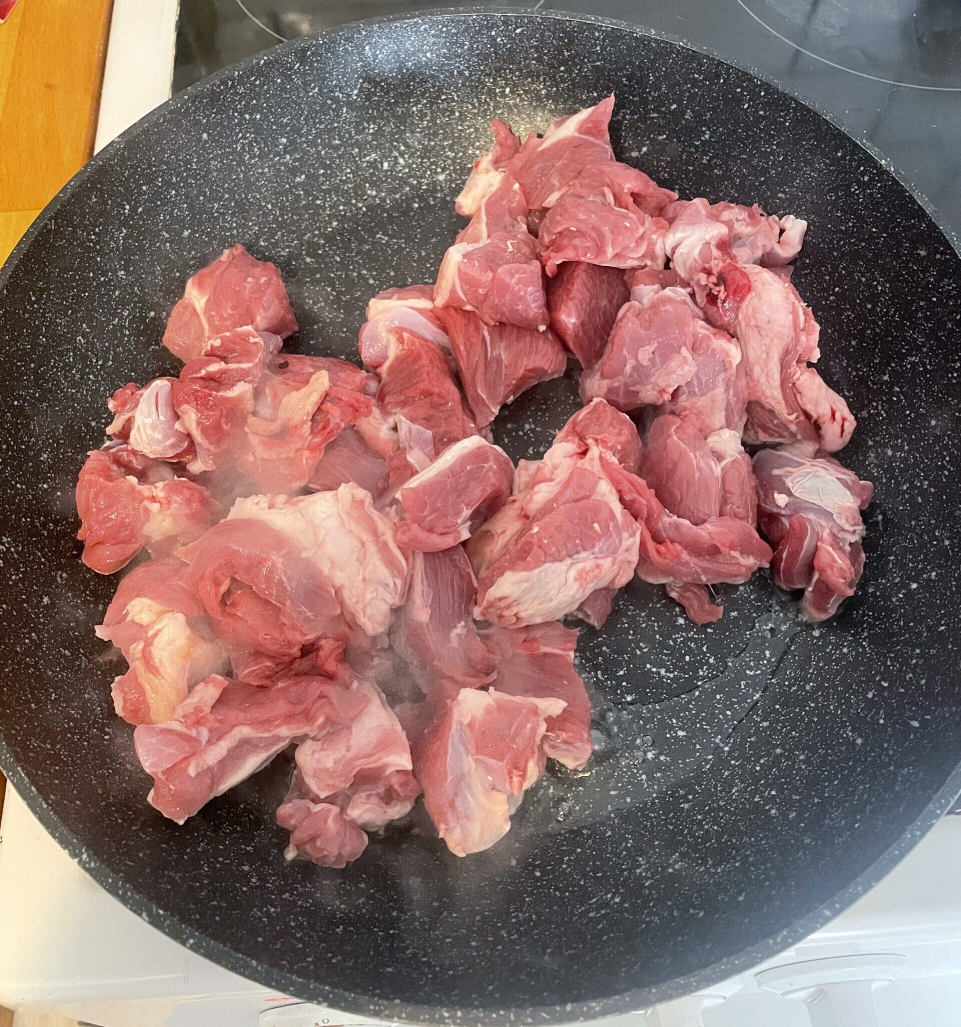 Raw lamb in a frying pan